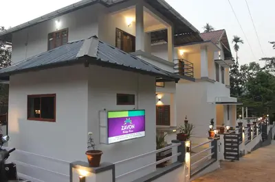 a house with a tv on the side of it at Zavon Holiday Home in Vythiri