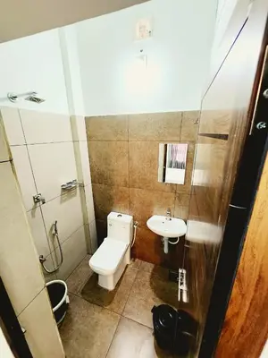 a bathroom with a toilet and a sink at Apsara Residency in Perintalmanna