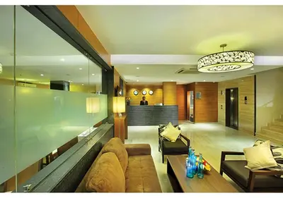 a living room with a couch and a table at Jk Park Residency Perambra in Mennānyam