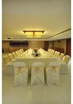 a large dining room with a long table and chairs at Jk Park Residency Perambra in Mennānyam