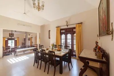 a kitchen and dining room with a table and chairs at Crystal Homestay by StayVista - 4BR in Madikeri