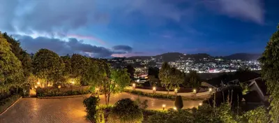 a view of a city at night at Club Mahindra Derby Green, Ooty in Ooty