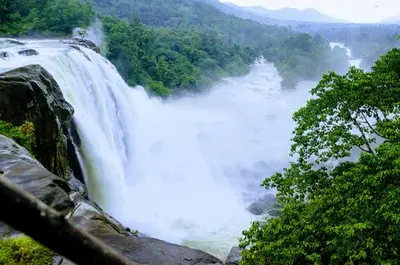 a large waterfall in the middle of a river at Jippus Galaxy Budget Air port hotel in Cochin