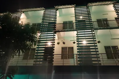a tall building with a bunch of windows and stairs at Jippus Galaxy Budget Air port hotel in Cochin