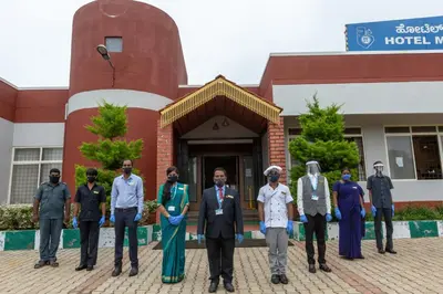a group of people standing in front of a building at KSTDC Hotel Mayura Biligiri, BR Hills in Honganūr