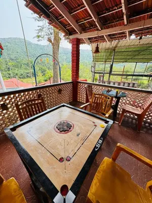 a ping pong table in the middle of a room at Coorg Heritage Hill View By The Avyaan in Madikeri