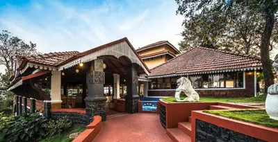 a house with a statue in front of it at The Porcupine Castle Resort in Madikeri