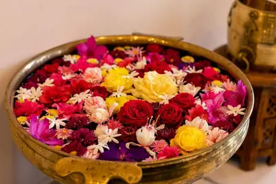 a bowl filled with colorful flowers on a table at StayVista at Aashirwaad Villa in Coonoor