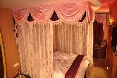 a bedroom with a bed with a pink canopy at Astoria Residency in Ooty