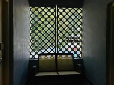 a room with a window and a bench with a bunch of plates at GoNest O Zen in Kozhikode
