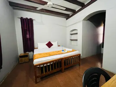 a bedroom with a bed in a room at GoNest O Zen in Kozhikode
