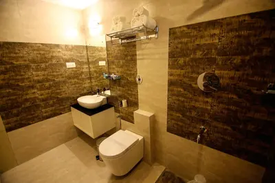 a bathroom with a toilet and a sink at Hotel Le Sapphire in Sultan Bathery