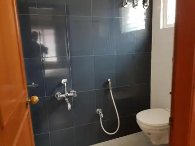 a bathroom with a shower with a toilet in it at Comfort`s Pearl in Coimbatore