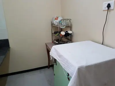 a hospital room with a bed and a table at Comfort`s Pearl in Coimbatore