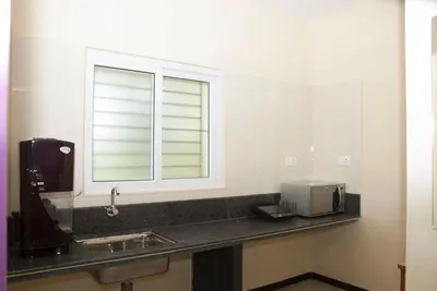 a bathroom with a sink and a window at Comfort`s Pearl in Coimbatore