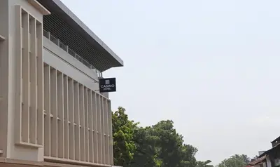 a building with a sign on the side of it at Treebo Casino in Kozhikode