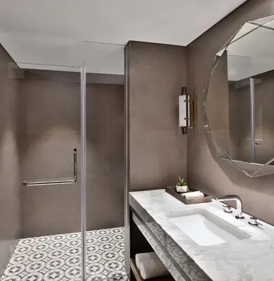 a bathroom with a sink and a shower at Port Muziris, A Tribute Portfolio Hotel by Marriott, Kochi Airport in Nedumbassery