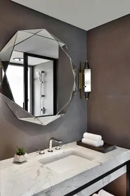 a bathroom with a sink and a large mirror at Port Muziris, A Tribute Portfolio Hotel by Marriott, Kochi Airport in Nedumbassery