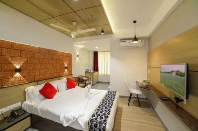 a bedroom with a large bed with red pillows at Bhavanam Regency Guruvayoor in Guruvāyūr