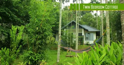a hammock in front of a tiny cabin in the forest at Vintage Garden Resort in Sultan Bathery