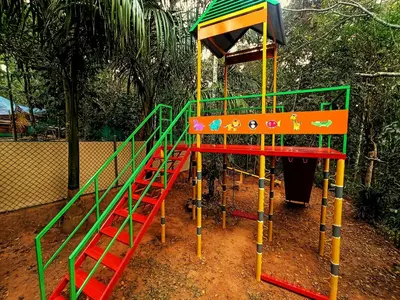 a playground with a slide in a park at Vintage Garden Resort in Sultan Bathery