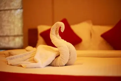a towel animal sitting on top of a bed at Bonita Banasura in Vythiri