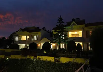 a large house at night with the lights on at Twin Tree in Kotagiri