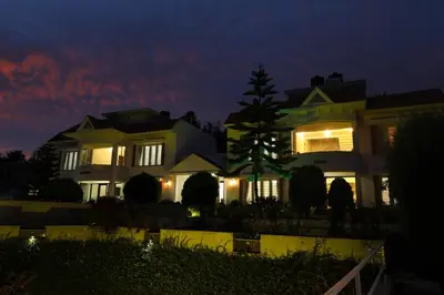 a large house at night with the lights on at Twin Tree in Kotagiri