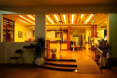 a lobby of a house with a staircase in it at Kallada hotels in Trichūr