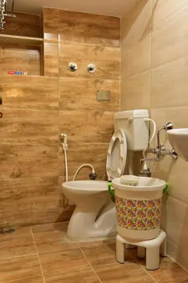 a bathroom with a toilet and a sink at Elegant Serviced Apartment in Mysore