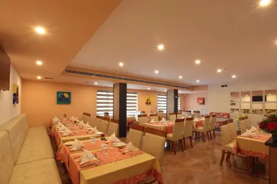 a restaurant with tables and chairs in a room at Hotel Park Residency Thrissur in Trichūr