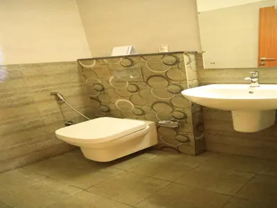 a bathroom with a toilet and a sink at Lalys Residency in Trichūr