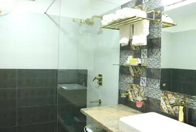a bathroom with a shower and a toilet and a sink at Lalys Residency in Trichūr