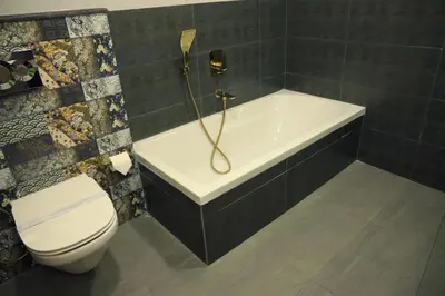 a bathroom with a bath tub and a toilet at Lalys Residency in Trichūr