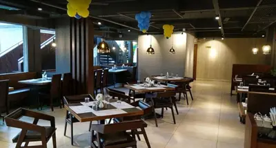 a dining room with tables and chairs and balloons at Lalys Residency in Trichūr