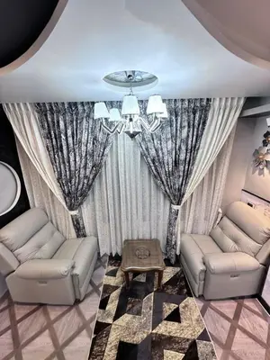 a living room with two couches and a chandelier at Beverly villa in Ooty