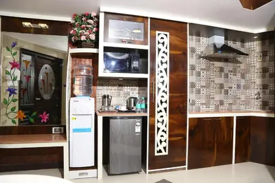 a kitchen with a refrigerator and a counter top at Beverly villa in Ooty