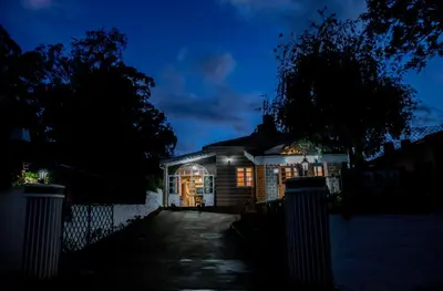 a house at night with its lights on at JJS Cottages in Coonoor