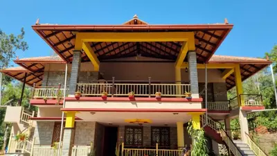 a large house with a balcony on top of it at Leela Farm Stay - Exclusive for Group Stay in Madikeri