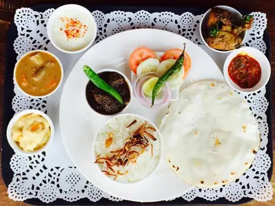 a plate of food with different types of food at Leela Farm Stay - Exclusive for Group Stay in Madikeri