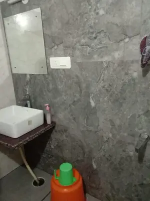 a bathroom with a sink and a mirror at Leela Farm Stay - Exclusive for Group Stay in Madikeri