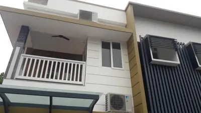 a white house with a balcony and a window at GOLDEN VILLA in Ernakulam