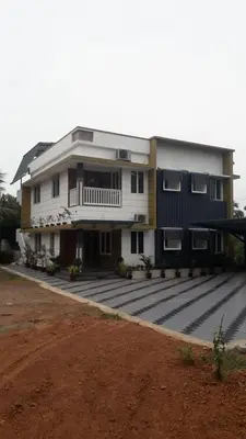 a large white house with a lot ofddsomaly at GOLDEN VILLA in Ernakulam