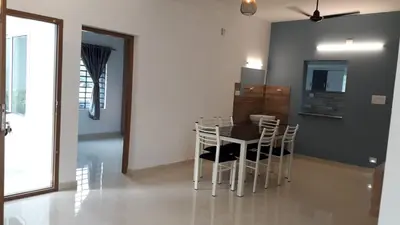 a dining room with a table and chairs at GOLDEN VILLA in Ernakulam