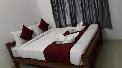 a bedroom with a bed with two white butterflies on it at GOLDEN VILLA in Ernakulam