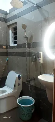 a bathroom with a toilet and a sink at Olive Inn Apartment in Alwaye