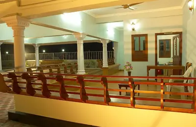 a porch with a wooden railing in a house at Sealine Beach Resorts in Cherai Beach