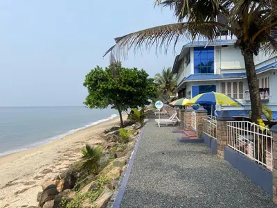 a house on the beach next to the ocean at Sealine Beach Resorts in Cherai Beach