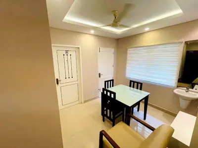 a room with a table and a sink and a toilet at KB RESIDENCY in Kozhikode