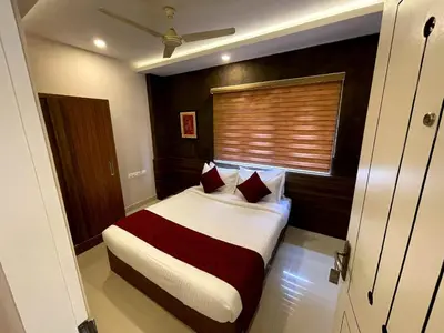 a bedroom with a large bed with a window at KB RESIDENCY in Kozhikode